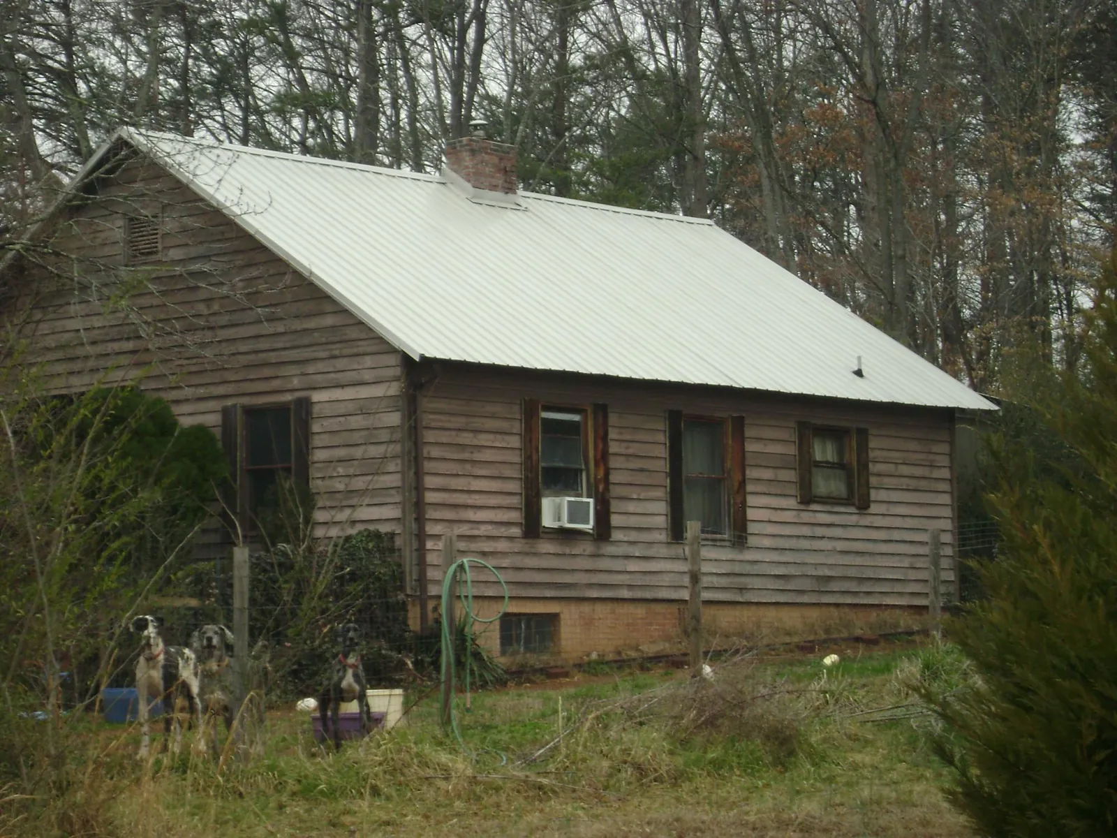 White metal roof on an old wood sided farmhouse, from a Metal Roof Installation job in Newbury Park
